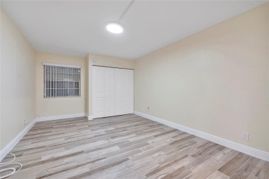Beautifully renovated 3-bedroom, 2-bathroom corner unit in Holly on Woodmont Country Club in Florida - for sale on GolfHomes.com, golf home, golf lot
