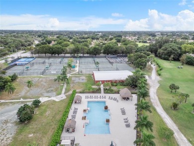 Beautifully renovated 3-bedroom, 2-bathroom corner unit in Holly on Woodmont Country Club in Florida - for sale on GolfHomes.com, golf home, golf lot