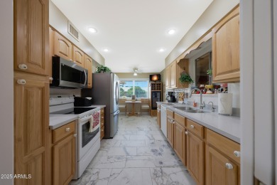 Stop By And View This Expanded Coconino Model Home On Hole on Sun City Lakes West and East in Arizona - for sale on GolfHomes.com, golf home, golf lot
