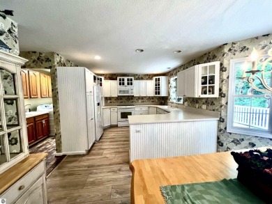 Discover unparalleled executive living perfectly situated on the on Traverse City Golf and Country Club in Michigan - for sale on GolfHomes.com, golf home, golf lot