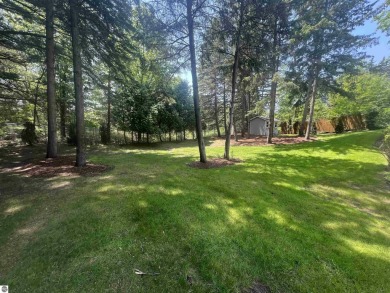 Discover unparalleled executive living perfectly situated on the on Traverse City Golf and Country Club in Michigan - for sale on GolfHomes.com, golf home, golf lot