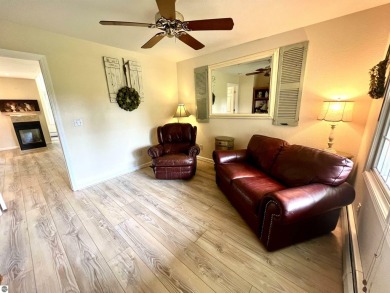 Discover unparalleled executive living perfectly situated on the on Traverse City Golf and Country Club in Michigan - for sale on GolfHomes.com, golf home, golf lot
