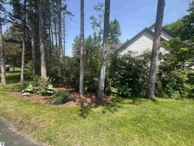 Discover unparalleled executive living perfectly situated on the on Traverse City Golf and Country Club in Michigan - for sale on GolfHomes.com, golf home, golf lot