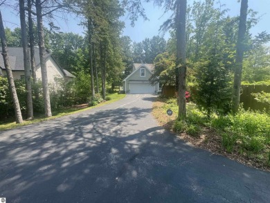 Discover unparalleled executive living perfectly situated on the on Traverse City Golf and Country Club in Michigan - for sale on GolfHomes.com, golf home, golf lot