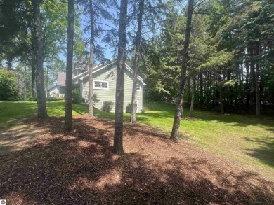 Discover unparalleled executive living perfectly situated on the on Traverse City Golf and Country Club in Michigan - for sale on GolfHomes.com, golf home, golf lot