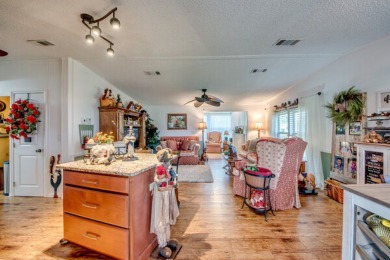 This great two-bed, two-bath home is located on the course at on Pine Lakes Country Club in Florida - for sale on GolfHomes.com, golf home, golf lot
