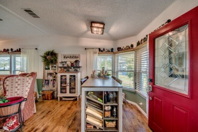 This great two-bed, two-bath home is located on the course at on Pine Lakes Country Club in Florida - for sale on GolfHomes.com, golf home, golf lot