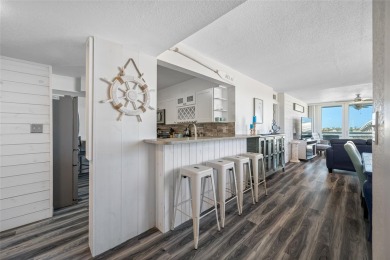 Stunning end unit offering water views galore!  This turnkey on Isla Del Sol Yacht and Country Club in Florida - for sale on GolfHomes.com, golf home, golf lot