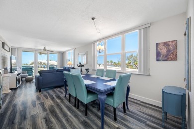 Stunning end unit offering water views galore!  This turnkey on Isla Del Sol Yacht and Country Club in Florida - for sale on GolfHomes.com, golf home, golf lot