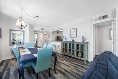 Stunning end unit offering water views galore!  This turnkey on Isla Del Sol Yacht and Country Club in Florida - for sale on GolfHomes.com, golf home, golf lot