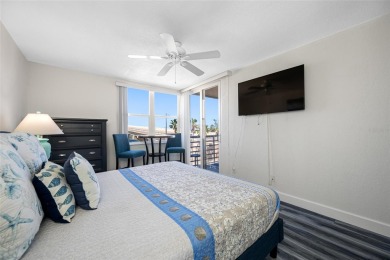 Stunning end unit offering water views galore!  This turnkey on Isla Del Sol Yacht and Country Club in Florida - for sale on GolfHomes.com, golf home, golf lot