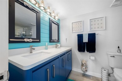Stunning end unit offering water views galore!  This turnkey on Isla Del Sol Yacht and Country Club in Florida - for sale on GolfHomes.com, golf home, golf lot