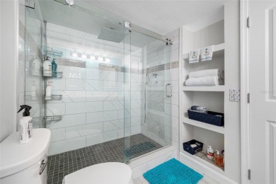 Stunning end unit offering water views galore!  This turnkey on Isla Del Sol Yacht and Country Club in Florida - for sale on GolfHomes.com, golf home, golf lot