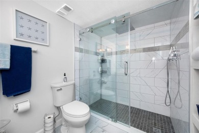 Stunning end unit offering water views galore!  This turnkey on Isla Del Sol Yacht and Country Club in Florida - for sale on GolfHomes.com, golf home, golf lot
