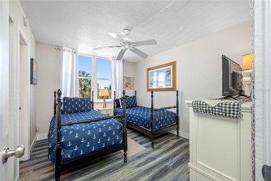 Stunning end unit offering water views galore!  This turnkey on Isla Del Sol Yacht and Country Club in Florida - for sale on GolfHomes.com, golf home, golf lot