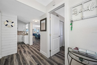 Stunning end unit offering water views galore!  This turnkey on Isla Del Sol Yacht and Country Club in Florida - for sale on GolfHomes.com, golf home, golf lot