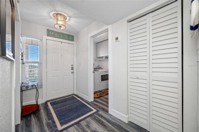 Stunning end unit offering water views galore!  This turnkey on Isla Del Sol Yacht and Country Club in Florida - for sale on GolfHomes.com, golf home, golf lot