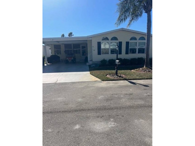 This home has been thoughtfully updated with laminate and tile on Hamptons Golf Club in Florida - for sale on GolfHomes.com, golf home, golf lot