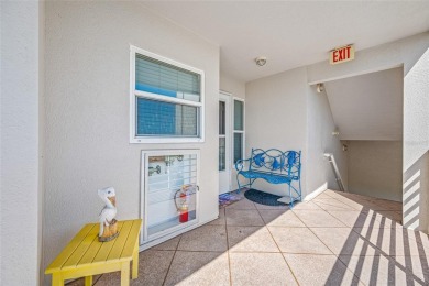 Stunning end unit offering water views galore!  This turnkey on Isla Del Sol Yacht and Country Club in Florida - for sale on GolfHomes.com, golf home, golf lot