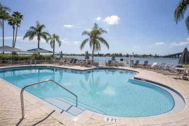 Stunning end unit offering water views galore!  This turnkey on Isla Del Sol Yacht and Country Club in Florida - for sale on GolfHomes.com, golf home, golf lot