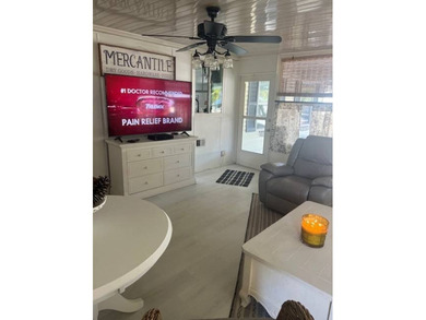 This home has been thoughtfully updated with laminate and tile on Hamptons Golf Club in Florida - for sale on GolfHomes.com, golf home, golf lot