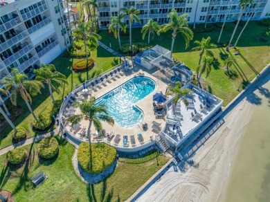 Stunning end unit offering water views galore!  This turnkey on Isla Del Sol Yacht and Country Club in Florida - for sale on GolfHomes.com, golf home, golf lot