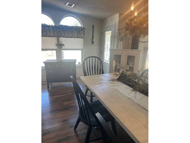 This home has been thoughtfully updated with laminate and tile on Hamptons Golf Club in Florida - for sale on GolfHomes.com, golf home, golf lot