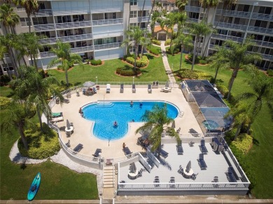Stunning end unit offering water views galore!  This turnkey on Isla Del Sol Yacht and Country Club in Florida - for sale on GolfHomes.com, golf home, golf lot