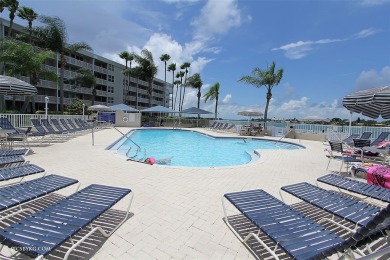 Stunning end unit offering water views galore!  This turnkey on Isla Del Sol Yacht and Country Club in Florida - for sale on GolfHomes.com, golf home, golf lot