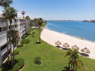 Stunning end unit offering water views galore!  This turnkey on Isla Del Sol Yacht and Country Club in Florida - for sale on GolfHomes.com, golf home, golf lot