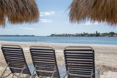 Stunning end unit offering water views galore!  This turnkey on Isla Del Sol Yacht and Country Club in Florida - for sale on GolfHomes.com, golf home, golf lot