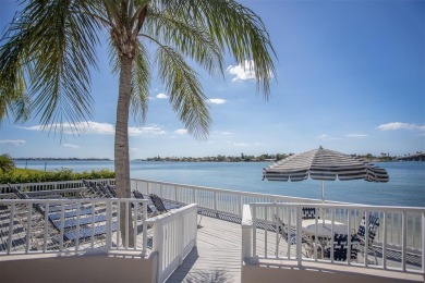Stunning end unit offering water views galore!  This turnkey on Isla Del Sol Yacht and Country Club in Florida - for sale on GolfHomes.com, golf home, golf lot