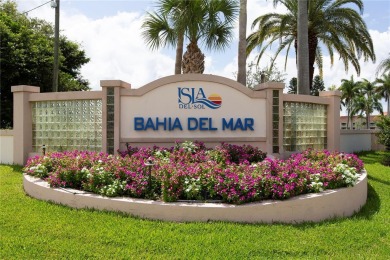Stunning end unit offering water views galore!  This turnkey on Isla Del Sol Yacht and Country Club in Florida - for sale on GolfHomes.com, golf home, golf lot