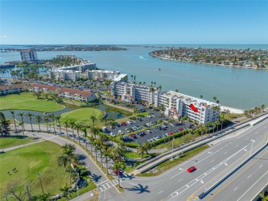 Stunning end unit offering water views galore!  This turnkey on Isla Del Sol Yacht and Country Club in Florida - for sale on GolfHomes.com, golf home, golf lot