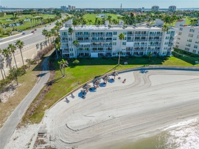 Stunning end unit offering water views galore!  This turnkey on Isla Del Sol Yacht and Country Club in Florida - for sale on GolfHomes.com, golf home, golf lot