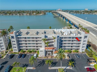 Stunning end unit offering water views galore!  This turnkey on Isla Del Sol Yacht and Country Club in Florida - for sale on GolfHomes.com, golf home, golf lot