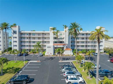 Stunning end unit offering water views galore!  This turnkey on Isla Del Sol Yacht and Country Club in Florida - for sale on GolfHomes.com, golf home, golf lot