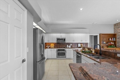 Tucked away among tree-lined streets and mature landscaping in on River Wilderness Golf and Country Club in Florida - for sale on GolfHomes.com, golf home, golf lot