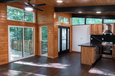 Amid towering hemlocks, this modern cabin reveals the quiet on Hide-A-Way Hills Golf Club in Ohio - for sale on GolfHomes.com, golf home, golf lot
