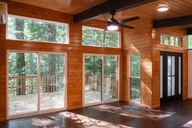Amid towering hemlocks, this modern cabin reveals the quiet on Hide-A-Way Hills Golf Club in Ohio - for sale on GolfHomes.com, golf home, golf lot