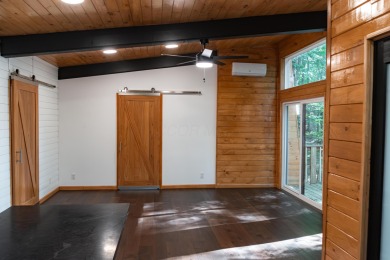 Amid towering hemlocks, this modern cabin reveals the quiet on Hide-A-Way Hills Golf Club in Ohio - for sale on GolfHomes.com, golf home, golf lot