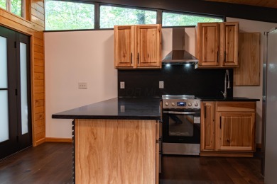 Amid towering hemlocks, this modern cabin reveals the quiet on Hide-A-Way Hills Golf Club in Ohio - for sale on GolfHomes.com, golf home, golf lot