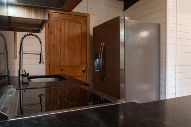 Amid towering hemlocks, this modern cabin reveals the quiet on Hide-A-Way Hills Golf Club in Ohio - for sale on GolfHomes.com, golf home, golf lot