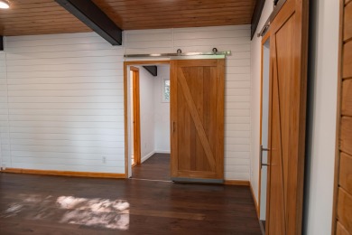 Amid towering hemlocks, this modern cabin reveals the quiet on Hide-A-Way Hills Golf Club in Ohio - for sale on GolfHomes.com, golf home, golf lot