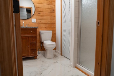 Amid towering hemlocks, this modern cabin reveals the quiet on Hide-A-Way Hills Golf Club in Ohio - for sale on GolfHomes.com, golf home, golf lot
