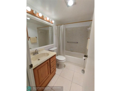 AFFORDABLE WINTER GET-AWAY!! GROUND FLOOR IN MOVE-IN CONDITION on Hillsboro Pines Golf in Florida - for sale on GolfHomes.com, golf home, golf lot