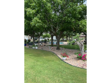 Nestled beneath an abundance of shade, located across the street on Legends Golf Course in Texas - for sale on GolfHomes.com, golf home, golf lot