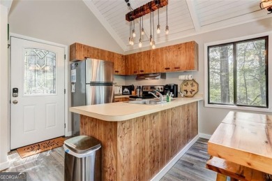 This spectacular villa offers seasonal views of Lake Petit and on Big Canoe Golf Club - Cherokee in Georgia - for sale on GolfHomes.com, golf home, golf lot