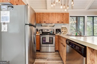 This spectacular villa offers seasonal views of Lake Petit and on Big Canoe Golf Club - Cherokee in Georgia - for sale on GolfHomes.com, golf home, golf lot