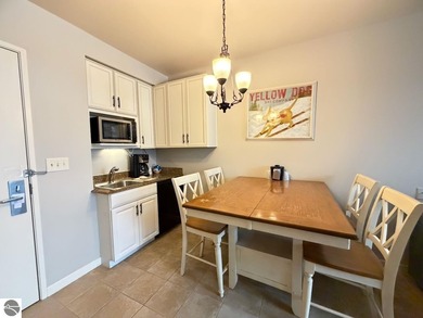 Enjoy views of the 18th hole and pond at the Lodge at Cedar on Schuss Mountain Golf Club in Michigan - for sale on GolfHomes.com, golf home, golf lot